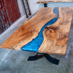 Metallic blue epoxy river dining table in live edge wood