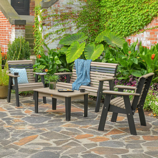 Bench and patio set with cozy decor on a stone patio, surrounded by greenery and ivy-covered walls.