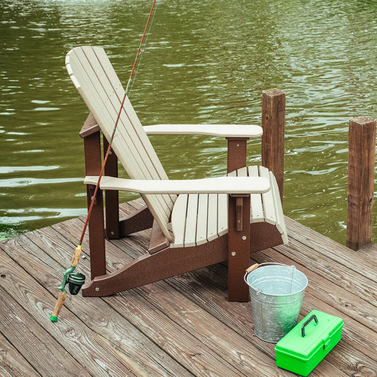 Adirondack chair on a dock by green water with fishing rod, bucket, and tackle box nearby.