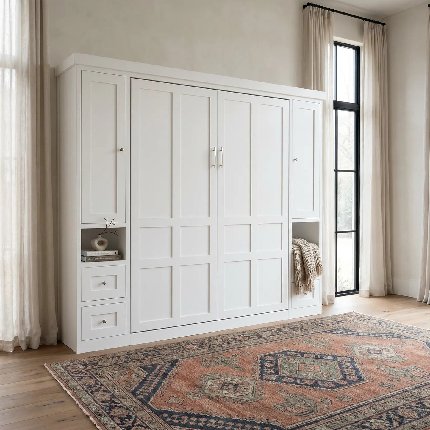 White murphy bed in a room with large windows and a patterned rug on the floor.