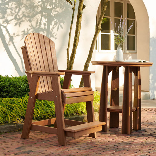 Adirondack chair and table on brick patio by white building; lavender vase, soft sunlight.
