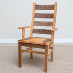 Wooden Akron Ladder Back Chair with arms on light carpet, rustic grain, simple wall behind.