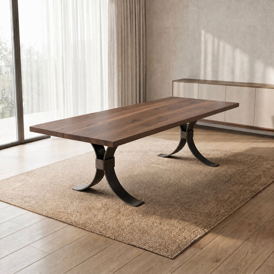 Modern dining room with a handmade wood table, steel base, beige rug, and light decor.