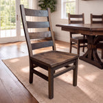 Akron Ladder Back chair of reclaimed barnwood on a rug by windows and greenery in dining room.