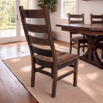 Akron Ladder Back Chair and table in a sunlit dining room with woven rug, wood floors, windows.