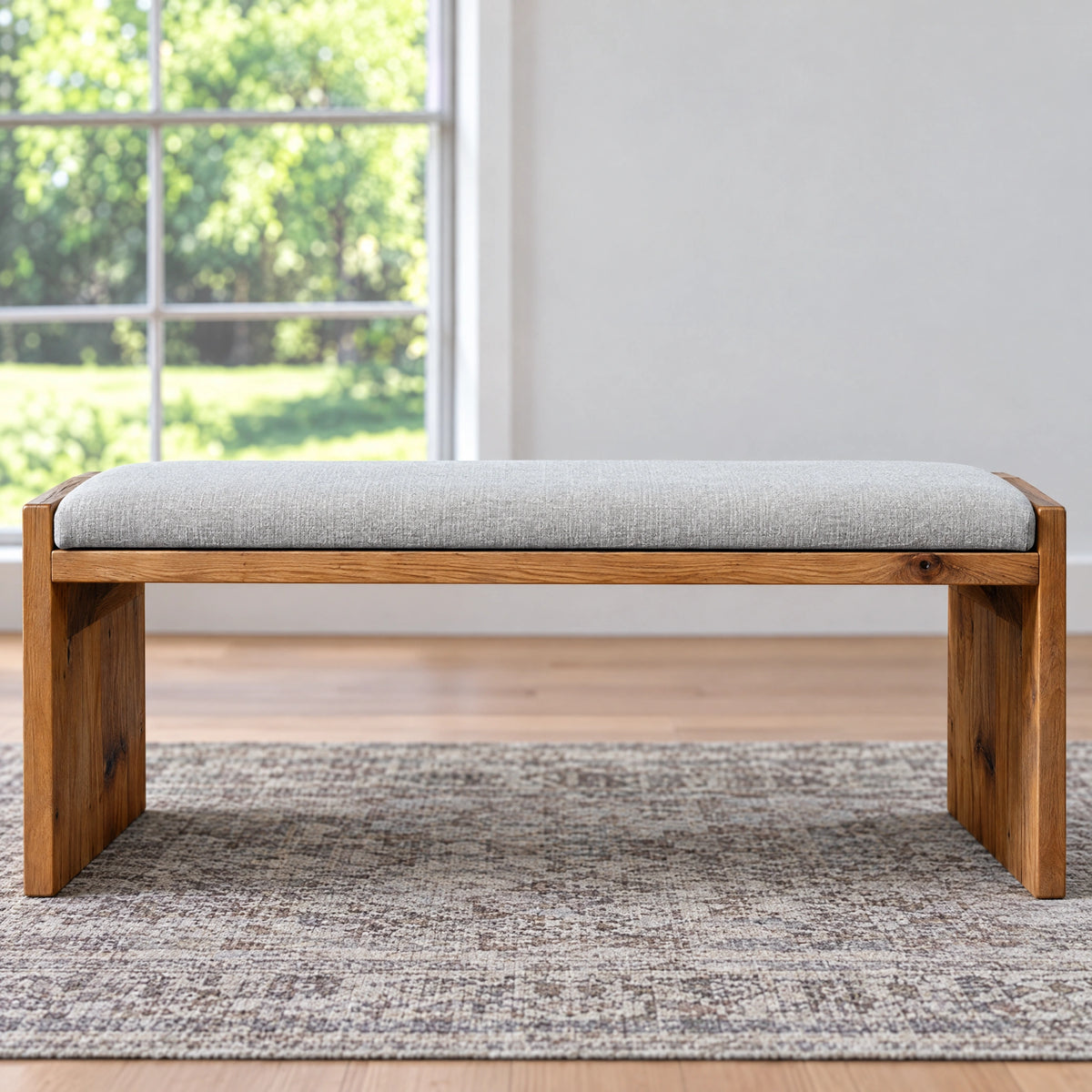 Ethan Wood Dining Bench with handcrafted wood and a light gray upholstered seat.