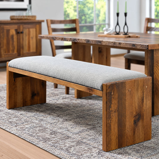 Ethan Wood Upholstered Dining Bench with a grey seat and brown wooden legs.