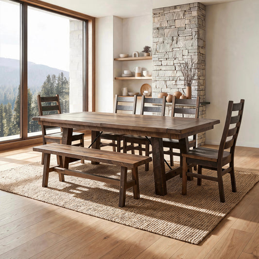 Rustic dining room with wood table, chairs, bench, stone wall, décor, and forested mountain view.