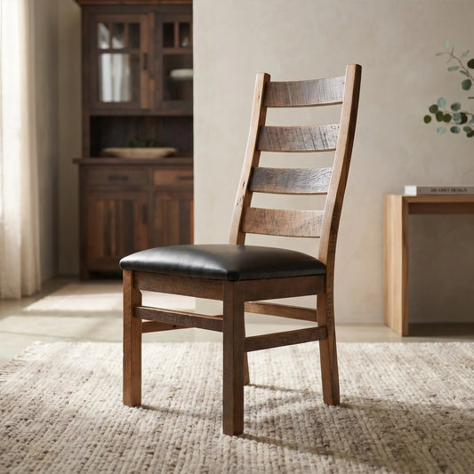 Aven ladder-back dining chair with black cushion on a rug in a softly lit, neutral room.