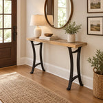 Boone Rustic Barnwood Sofa Table with a reclaimed barnwood top and curved black metal legs.