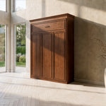 Closed Brookview Murphy Bed against beige wall in a bright room with herringbone floors, large windows.