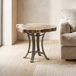 Live edge walnut end table with steel base beside beige sofa on light wood floor in modern room.