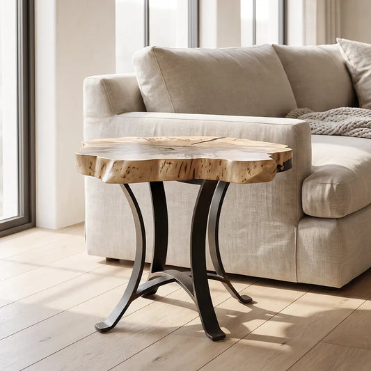 Live edge maple end table with black base next to beige sofa in a bright, windowed room.