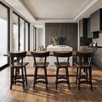 Modern kitchen with marble island, wood floor, dark cabinets, and large windows for natural light.