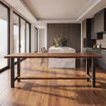 Modern kitchen with large windows, wood floors, marble island, and a live edge walnut table.
