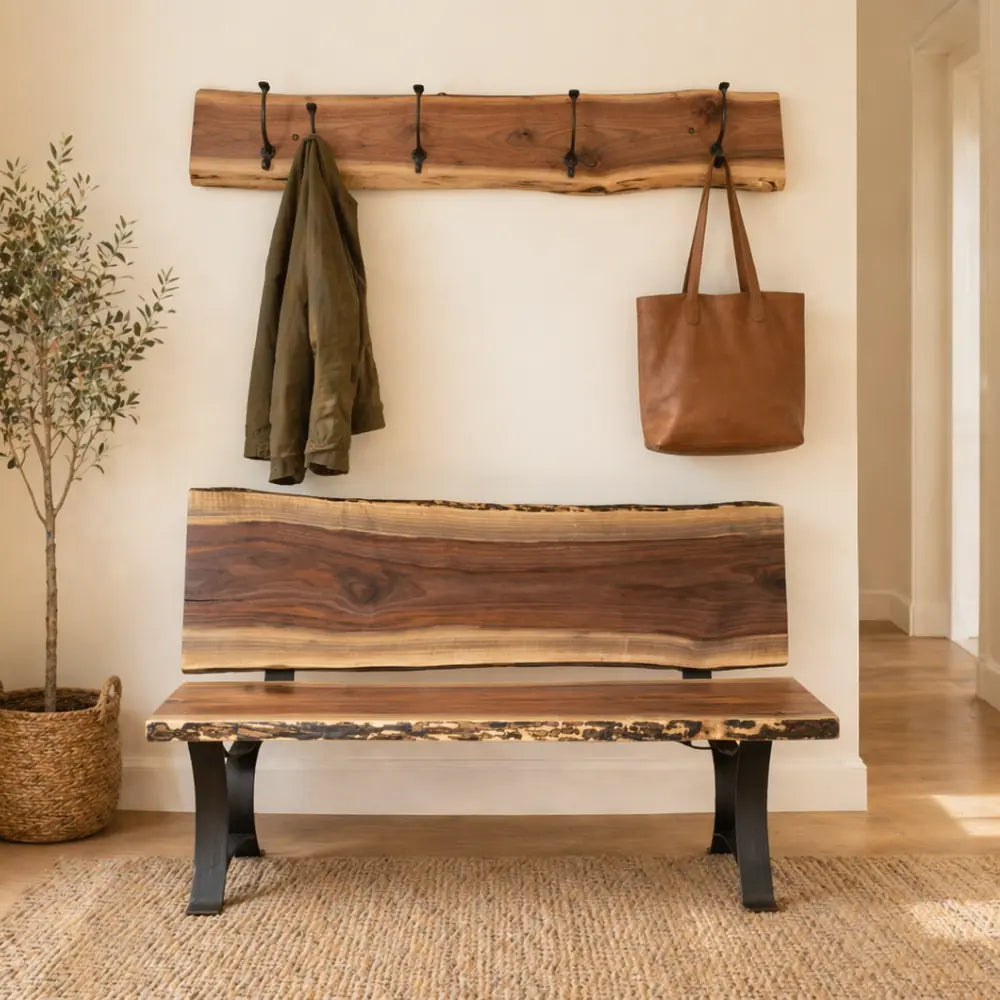 Cozy entryway with live edge bench, coat rack, green jacket, tote, rug, and wood floors.