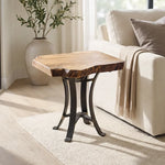 Live edge sycamore end table on beige rug by cream sofa and plant in sunlit room.
