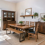 Bright, airy dining room with wood table, Martin Bench, plants, and decor on a cozy rug.