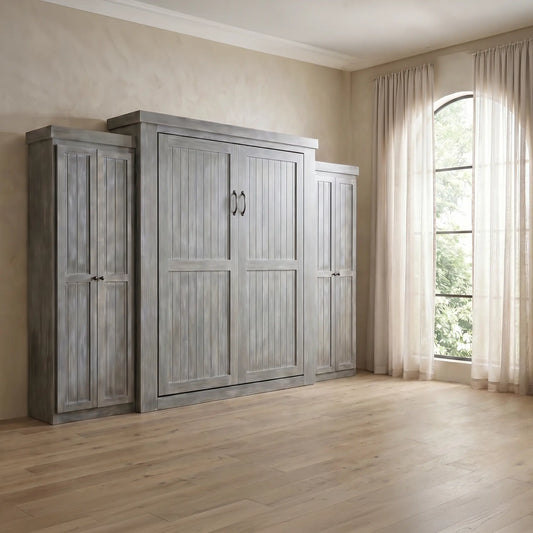 Gray handcrafted Murphy bed with double doors flanked by cabinets in a bright, airy room.