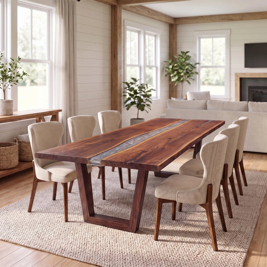 Walnut live edge river dining table with angled base and six upholstered chairs on a rug.