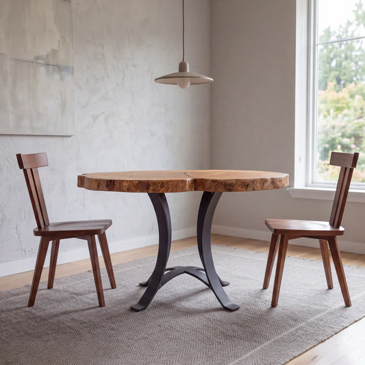 Live edge ash cafe table with two chairs on a gray rug in a bright room with large window.