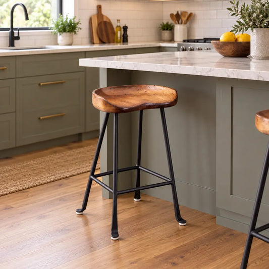 Molded wood tractor seat counter stool with a black steel base in a kitchen.