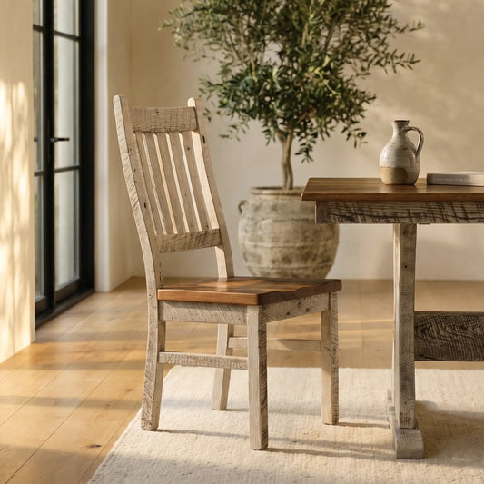 Farmhouse chair and table with jug on rug, potted plant, and sunlight create a cozy space.
